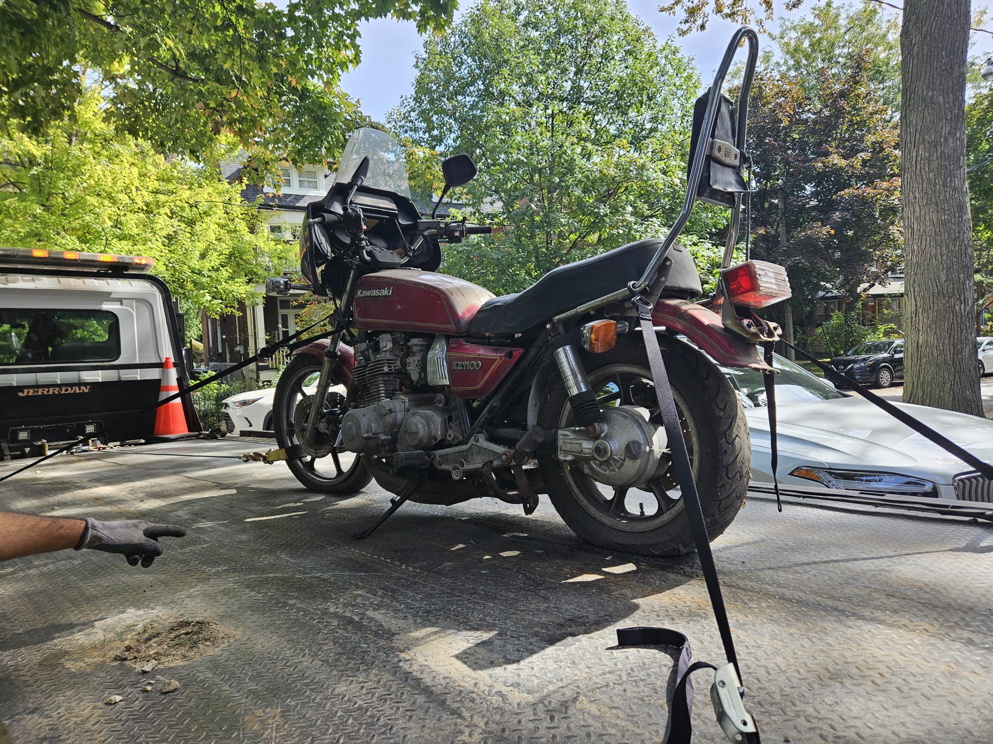 scrap motorcycle being towed